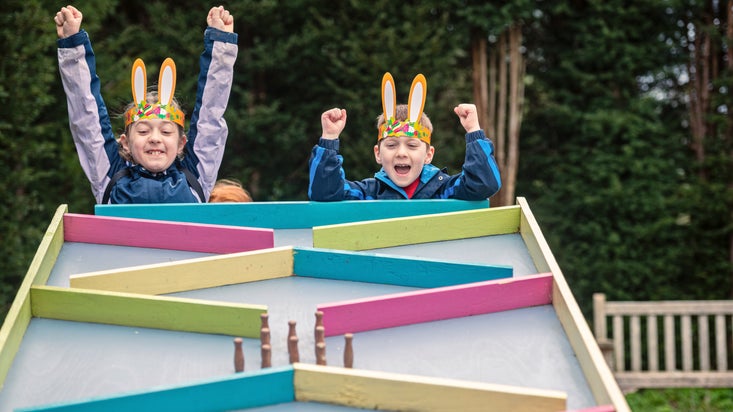 Children celebrating a win on the egg run during the Easter Adventures Trail at Dyffryn Gardens, Vale of Glamorgan